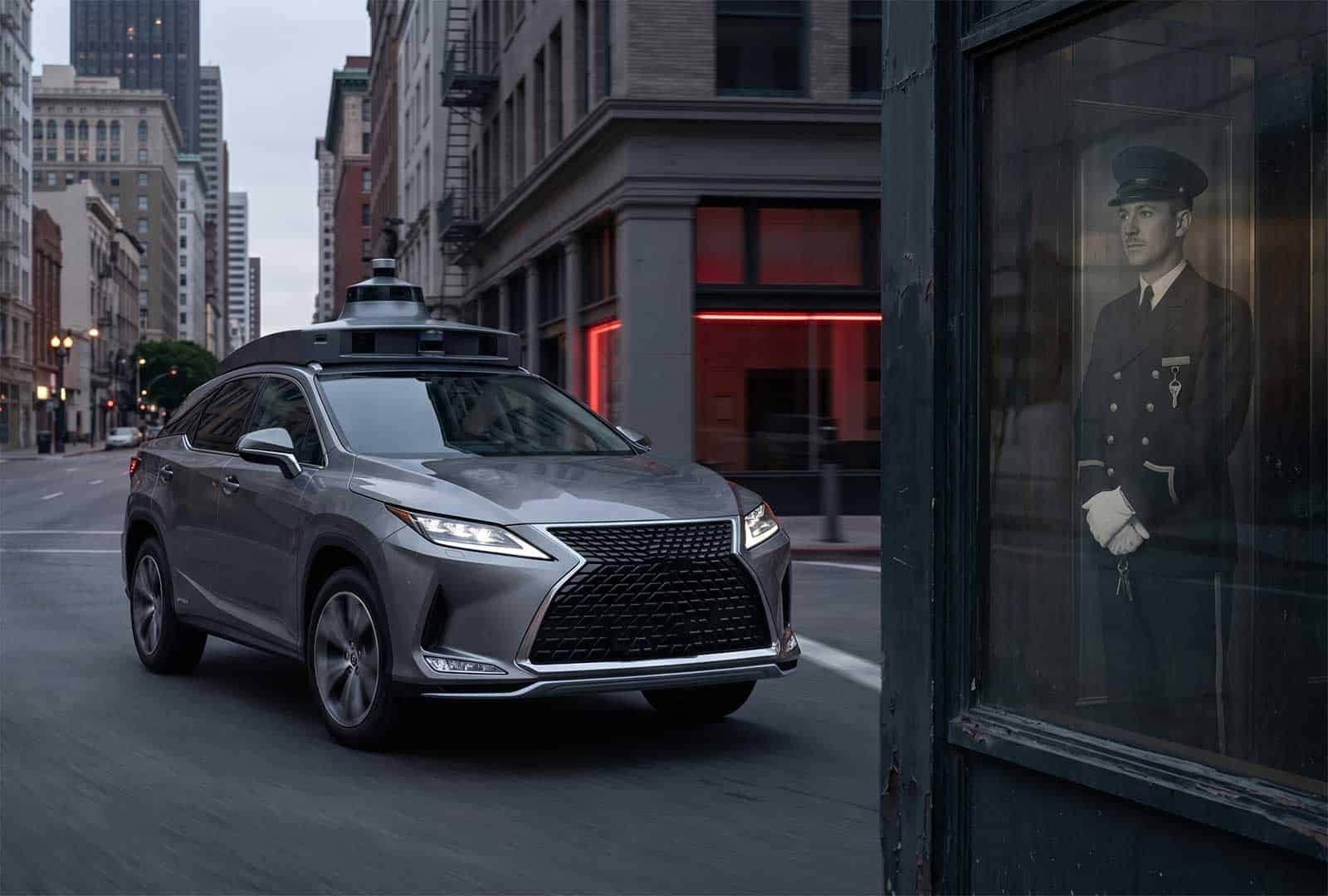 Autonomous car driving past a bus stop with a uniformed officer image.