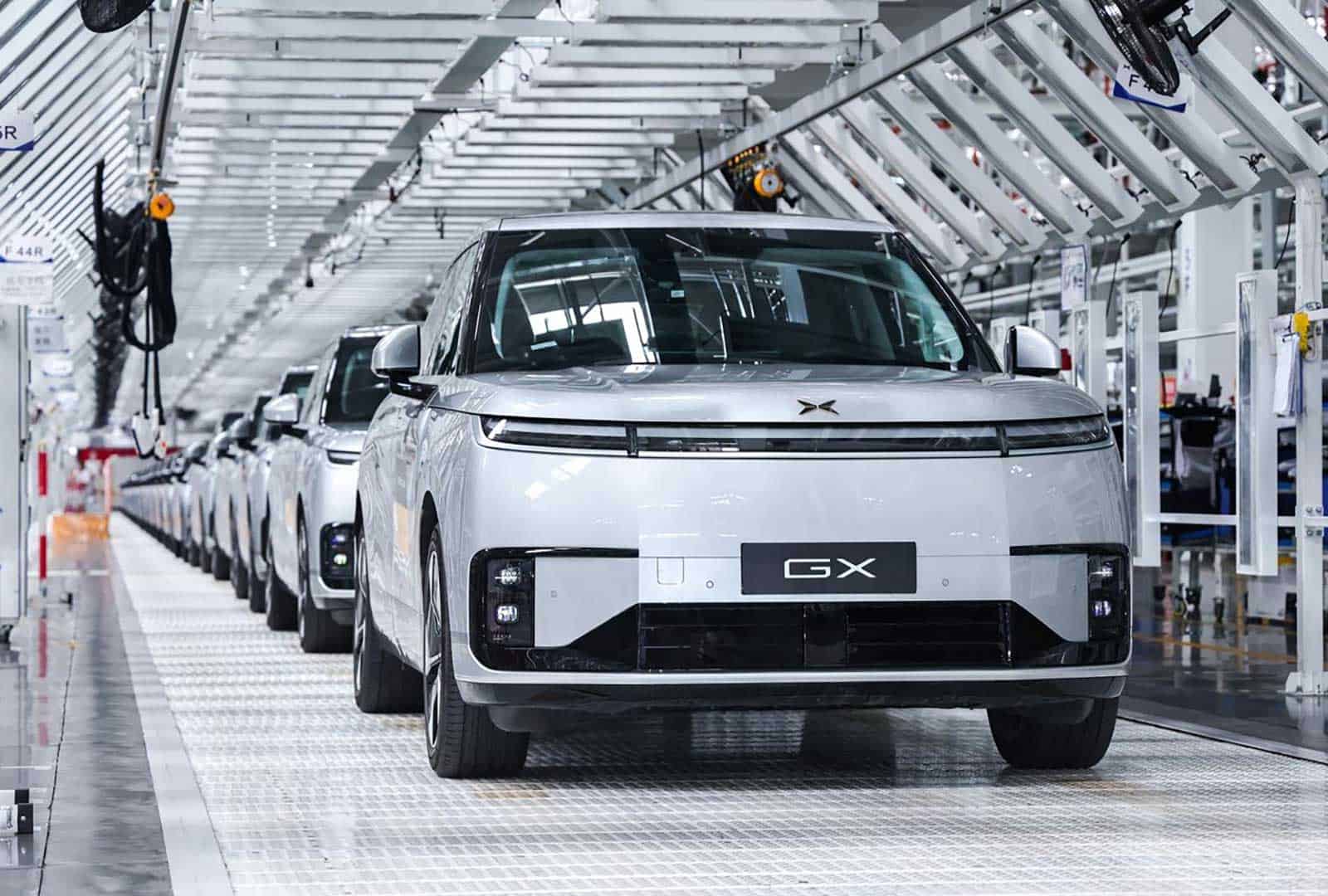 Autonomous electric vehicle on assembly line in modern factory setting.