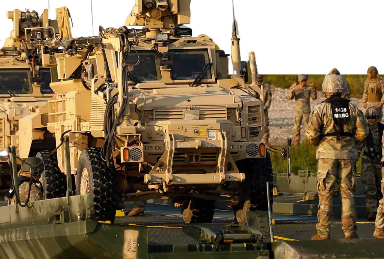U.S. Army soldiers and autonomous military vehicles in operation.