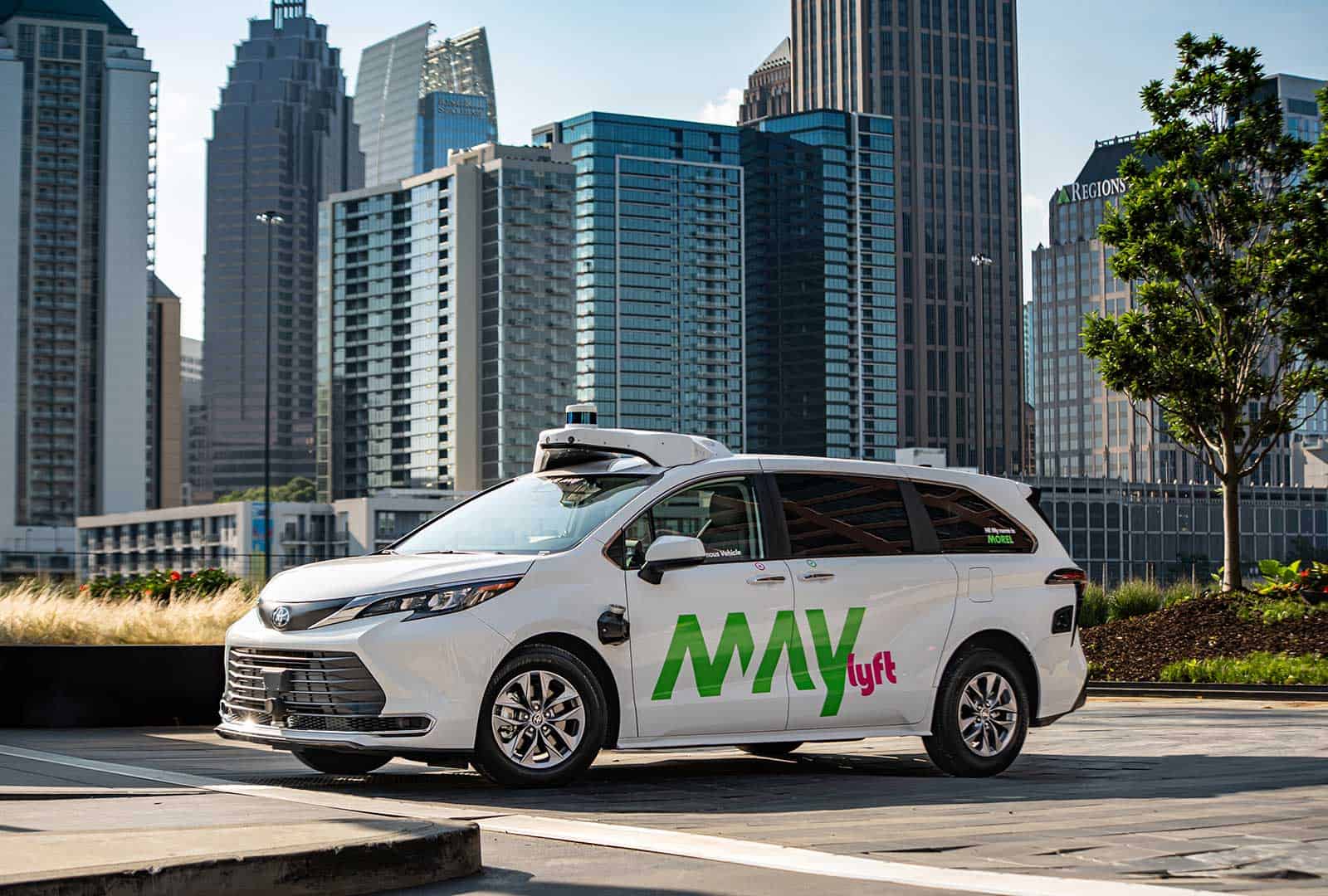 Autonomous vehicle by May Mobility in urban downtown setting.