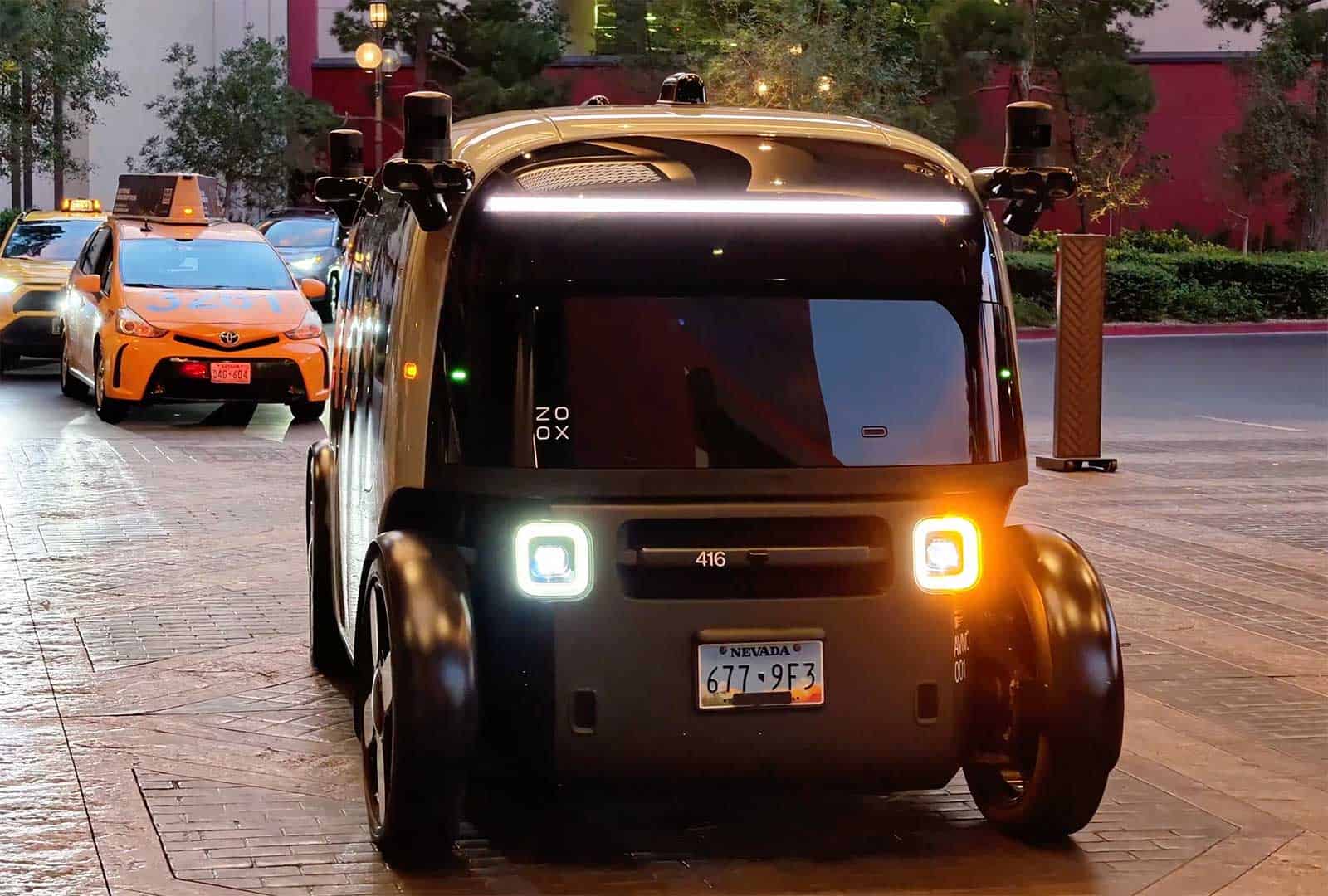 Autonomous delivery robot with headlights on at T-Mobile Arena.